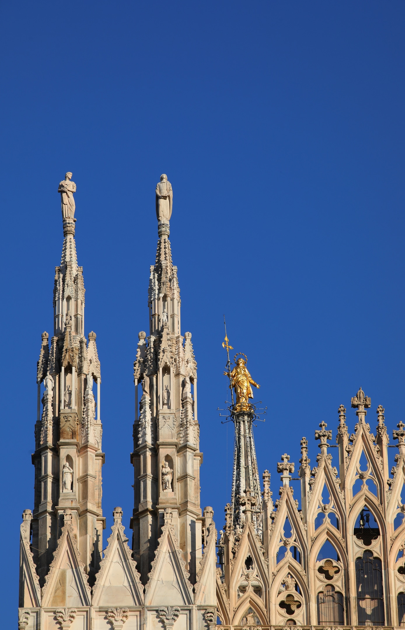 Duomo rooftop spires and golden Madonnina